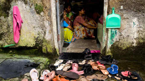 Women attend a meeting to learn about microloans at the Ujjivan microcredit firm in Mumbai, on Sept. 24, 2010