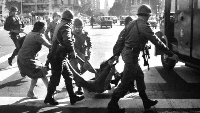 A woman tries desperately to prevent detention of a young man by police during anti-government rally in Buenos Aires during the last days of Argentina's Dirty War. A 1976 coup resulted in a 7-year military dictatorship in which an estimated 30,000 people were killed or &quot;disappeared&quot; at the hands of the military. (Photo by Horacio Villalobos/Corbis via Getty Images)