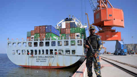 TO GO WITH 'PAKISTAN-ECONOMY-POVERTY' by Ashraf KHAN In this photograph taken on November 13, 2016, Pakistani Naval personnel stand guard near a ship carrying containers at the Gwadar port, some 700 kms west of Karachi, during the opening ceremony of a pilot trade programme between Pakistan and China. Shah Nawaz walks Karachi's dusty streets, one of thousands in the financial hub who are being fed by charities as Pakistan's economy picks up pace -- but, some say, not fast enough for its poverty-stricken millions. Confidence in Pakistan is growing, with the International Monetary Fund claiming in October 2016 that the country has emerged from crisis and stabilised its economy after completing a bailout programme. / AFP / AAMIR QURESHI / TO GO WITH 'PAKISTAN-ECONOMY-POVERTY' BY ASHRAF KHAN (Photo credit should read AAMIR QURESHI/AFP/Getty Images)