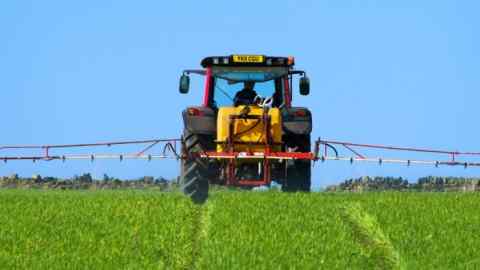 DYKKYD Farmer spraying crops near Thurstonland, Holme Valley, West Yorkshire, England, UK