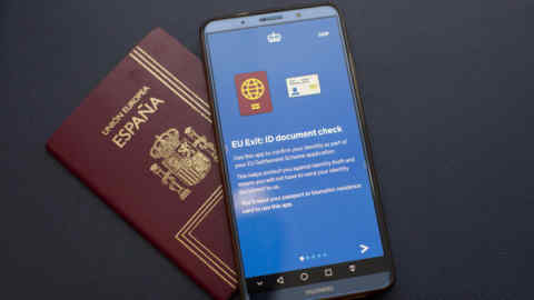 The Home Office's EU Exit: ID Document Check app on a Huawei phone, next to a Spanish passport. Researchers have found major loopholes that allowed them to take control of the app