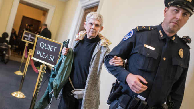 UNITED STATES - FEBRUARY 15: Harriotte Ranvig, 71, of Somerville Mass., is escorted out of the House chamber on February 15, 2018, after she and a group of protesters disrupted the vote on The ADA Education and Reform Act on which makes it harder for disabled people to sue for discrimination. The aim of the legislation is to curb dishonest lawsuits. (Photo By Tom Williams/CQ Roll Call)