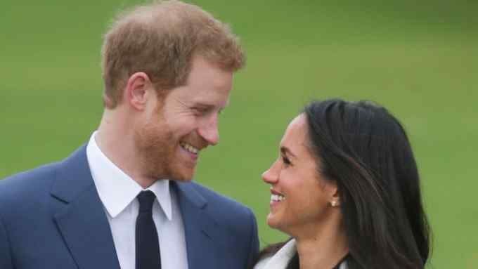 (FILES) In this file photo taken on November 27, 2017 Britain's Prince Harry and his fiancée US actress Meghan Markle pose for a photograph in the Sunken Garden at Kensington Palace in west London on November 27, 2017, following the announcement of their engagement. Prince Harry, who marries US former actress Meghan Markle on May 19, 2018 has been transformed in recent years from an angry young man into one of the British royal family's greatest assets. / AFP PHOTO / Daniel LEAL-OLIVASDANIEL LEAL-OLIVAS/AFP/Getty Images