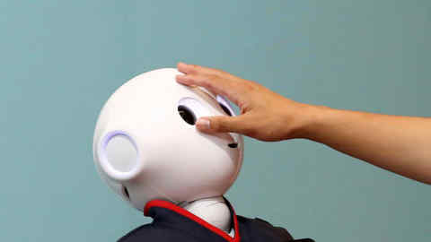 GDNYWM A man touches the head of a SoftBank humanoid robot known as Pepper at the venue for Pepper World 2016 Summer, ahead of its opening on Thursday, in Tokyo, Japan, July 20, 2016. REUTERS/Kim Kyung-Hoon