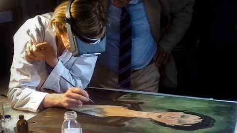 In this picture taken on Thursday, June 9, 2016, restorer Luana Casaglia conducts tests at the COOBEC laboratories in Spoleto, central Italy, on a painting recently emerged and under investigation to determine whether it is an authentic work by Italian 20th century master Amedeo Modigliani. (COOBEC via AP)