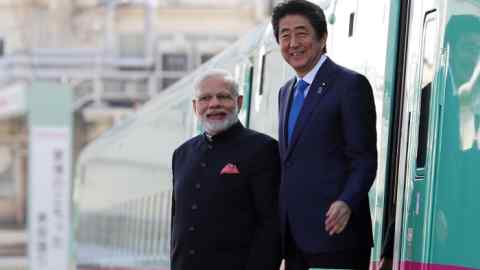Narendra Modi, India's prime minister, left, and Shinzo Abe, Japan's prime minister, leave an E5 series Shinkansen bullet train during a visit to a plant of Kawasaki Heavy Industries Ltd.'s Rolling Stock Co. in Kobe, Hyogo Prefecture, Japan, on Saturday, Nov. 12, 2016. Modi meets Abe in Japan, almost a year after the Indian leader picked Japan as a partner for the nation's first line -- a 980-billion-rupee ($15 billion) rail linking Mumbai and Ahmedabad, roughly the distance from Paris to London. Abe hopes that will make Japan the front-runner if India implements five other planned lines. Photographer: Buddhika Weerasinghe/Bloomberg
