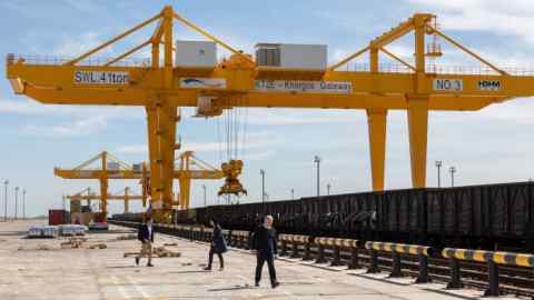 This file photo taken on April 15, 2019 shows the KTZE-Khorgos Gateway Dry port, a logistics hub on the Kazakh side of the Kazakhstan-Chinese border, on April 15, 2019. - Traders travel freely through the bustling Khorgos special economic zone that straddles the Kazakhstan-China border, but signs on the Chinese side bear a blunt warning -- no veils or long beards allowed. It's a stark reminder of the severe security policies that China has imposed on mostly Muslim ethnic minorities in its vast border region of Xinjiang, which it considers crucial to the success of President Xi Jinping's cherished Belt and Road Initiative (BRI). (Photo by ABDUAZIZ MADYAROV / AFP) (Photo credit should read ABDUAZIZ MADYAROV/AFP/Getty Images)