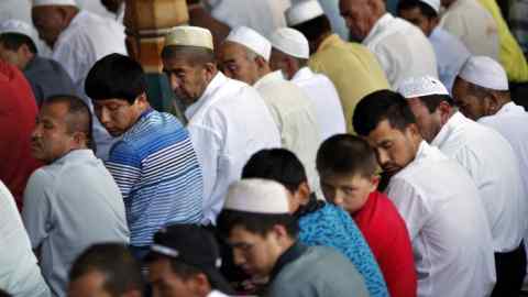 Ethnic Uighur men pray at a mosque during Ramadan in Kashgar city, in Xinjiang province...Ethnic Uighur men pray at a mosque during Ramadan in Kashgar city, in Xinjiang province August 4, 2011. The biggest threat to China's grip on its ethnically divided far western frontier comes from homegrown anger exploding in violence, not from Pakistan-based terrorists officials have blamed for the latest bloodshed. China said ringleaders of the separatist &quot;East Turkestan Islamic Movement&quot; (ETIM) who trained in Pakistan orchestrated the assault on Sunday that killed six in Kashgar city, Xinjiang region, where many Muslim Uighur resent the presence of Han Chinese people. REUTERS/Carlos Barria (CHINA - Tags: POLITICS RELIGION CIVIL UNREST) - RTR2PLQA