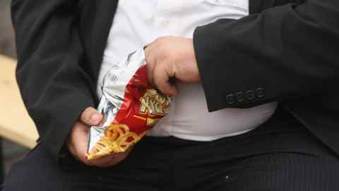 LEIPZIG, GERMANY - MAY 23:  A man with a large belly eats junk food on May 23, 2013 in Leipzig, Germany. According to statistics a majority of Germans are overweight and are comparatively heavier than people in most other countries in Europe.  (Photo by Sean Gallup/Getty Images)