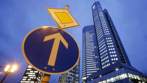 The headquarters of Deutsche Bank is photographed next to a traffic sign in Frankfurt, Germany, Wednesday, Jan. 28, 2015. The Deutsche Bank will present its fourth quarter balance sheet on Thursday. (AP Photo/Michael Probst)