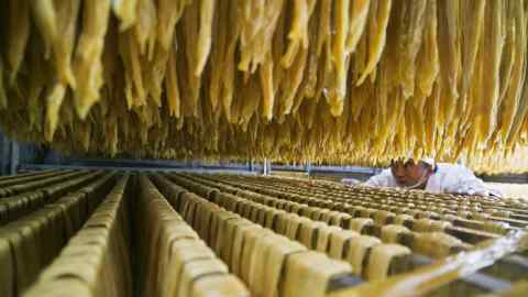 In this Jan. 10, 2019, photo released by Xinhua News Agency, a worker checks on a soybean food at a processing factory in Xiaotun Township of Dafang County in Bijie, southwest China's Guizhou Province. China's trade growth slowed in 2018 as a tariff battle with Washington heated up and global consumer demand weakened. Exports rose 7.1 percent, customs data showed Monday, Jan. 14, 2019 down from the 7.9 percent reported earlier for 2017. Import growth declined to 12.9 percent from the previous year's 15.9 percent. (Luo Dafu/Xinhua via AP)