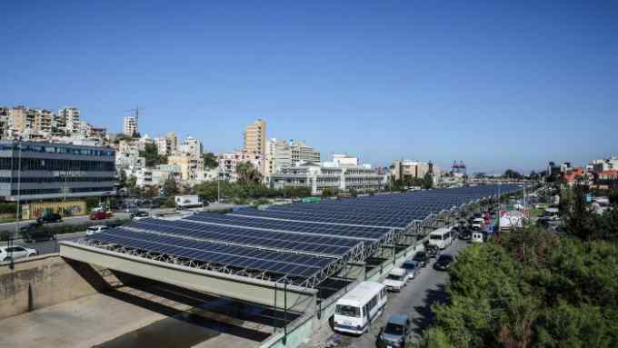 Photovoltaic panels are seen above the river bed in the Lebanese capital, Beirut, on November 12, 2015. As part of the government's National Energy Efficiency Action Plan (NEEAP) to install 200 MW of solar farms by 2020 the construction of the Beirut River Solar Snake (BRSS) project, is the largest of its kind on a national level. BRSS consists of the installation of 10 MW of energy via a photovoltaic (PV) farm stretching across 30 meters of the Beirut River. The PV farm will feature a fully suspended design with no obstruction in the river, offering a capacity of 1.08 MWp. AFP PHOTO / JOSEPH EID / AFP / JOSEPH EID (Photo credit should read JOSEPH EID/AFP/Getty Images)