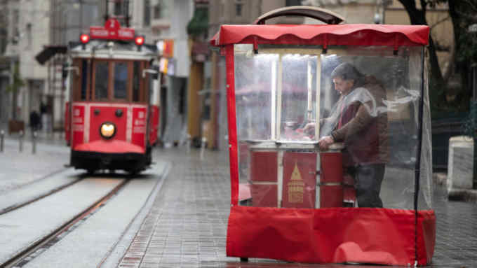 Mandatory Credit: Photo by TOLGA BOZOGLU/EPA-EFE/Shutterstock (10592229d) A street seller waits for customers at Istiklal Street, barely populated because of concerns against spreading the coronavirus and COVID-19 disease, in Istanbul, Turkey, 24 March 2020. Turkish Health Minister Fahrettin Koca said on 23 March that there are 1,529 confirmed cases of the coronavirus and 37 related deaths from COVID-19. Turkey decided to halt public events, temporarily shut down schools and suspend sporting events in an attempt to prevent further spreading of the coronavirus. Coronavirus and COVID-19 disease affects life in Turkey, Istanbul - 24 Mar 2020