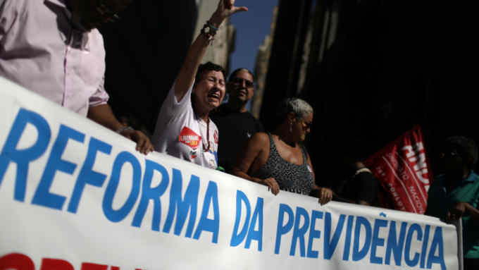 Demonstrators hold a sign during a protest against Brazil's President Jair Bolsonaro in Rio de Janeiro, Brazil May 20, 2019. The sign reads: &quot;Pension reform.&quot; REUTERS/Pilar Olivares