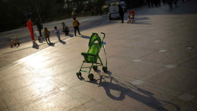 A baby stroller is seen as mothers play with their children at a public area in downtown Shanghai...A baby stroller is seen as mothers play with their children at a public area in downtown Shanghai November 19, 2013. China will further ease its family planning laws after announcing last week that it would allow millions of families to have two children, a senior official from the government's family planning commission said on Tuesday. REUTERS/Carlos Barria (CHINA - Tags: POLITICS SOCIETY TPX IMAGES OF THE DAY) - RTX15JXU