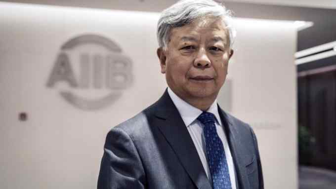 Jin Liqun, president of the Asian Infrastructure Investment Bank (AIIB), stands for a photograph following a Bloomberg Television interview at the bank's headquarters in Beijing, China, on Thursday, Jan. 5 2017. One year after opening with 57 charter members, the China-led AIIB remains open to the U.S. joining, Jin said. Photographer: Qilai Shen/Bloomberg