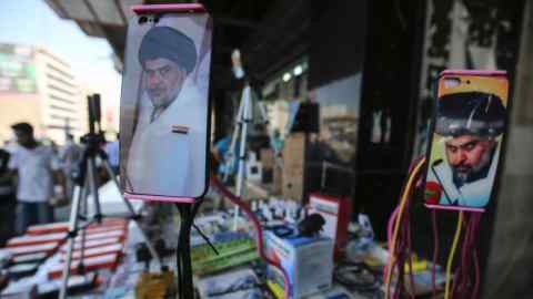 A picture taken on May 17, 2018 shows the face of Iraqi Shiite cleric and leader Muqtada al-Sadr adorning the plastic covers of cell phones, on display at a peddlar's stall in a market street in the capital Baghdad. Sadr, the fiery Shiite preacher who was the bete noire of American forces during the US invasion, captured the most seats in parliament after his improbable alliance with Iraq's communists tapped popular anger over corruption and foreign interference and reshaped the country's political landscape. / AFP PHOTO / AHMAD AL-RUBAYEAHMAD AL-RUBAYE/AFP/Getty Images