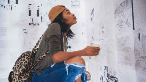 A visitor reads inmates’ letters at ‘The Writing on the Wall’