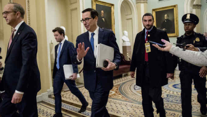 Treasury Secretary Steven Mnuchin, third from left, and White House Legislative Affairs Director Eric Ueland, left, walk to a meeting with Senate Minority Leader Sen. Chuck Schumer of N.Y. in his office on Capitol Hill, Monday, March 23, 2020, in Washington. The Senate is working to pass a coronavirus relief bill. (AP Photo/Andrew Harnik)
