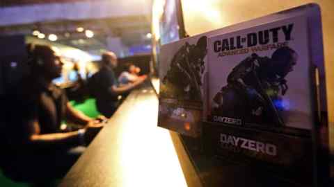 Visitors play the &quot;Call of Duty Advanced Warfare&quot; video game, produced by Activision Blizzard Inc., on Microsoft Corp. Xbox One games consoles during the EGX gaming conference at Earls Court in London, U.K., on Thursday, Sept. 25, 2014. Sony Corp. will begin selling its PlayStation TV set-top box in the U.S. and Europe next month with almost 700 games available, including select Angry Birds, Borderlands, Lego and FIFA soccer titles. Photographer: Chris Ratcliffe/Bloomberg