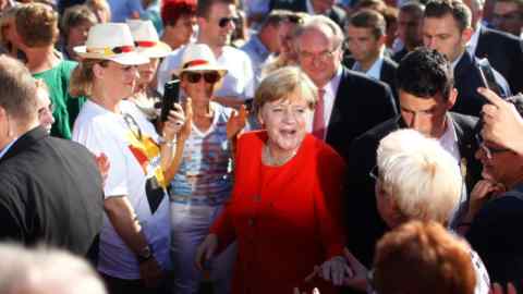 German Chancellor Angela Merkel, top candidate for the upcoming general elections of the Christian Democratic Union party (CDU), greets supporters during an election campaign rally in Bitterfeld-Wolfen, Germany, August 29, 2017. REUTERS/Hannibal Hanschke