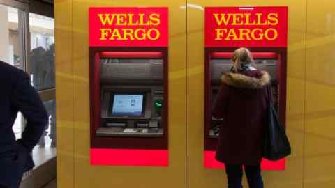 A customer uses an automatic teller machine (ATM) inside a Wells Fargo & Co. bank branch in New York, U.S., on Friday, Jan. 5, 2018. Wells Fargo & Co. is scheduled to release earnings figures on January 12. Photographer: Daniel Tepper/Bloomberg