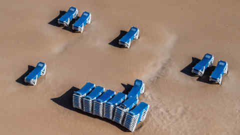 BENIDORM, SPAIN - MAY 11: Sun loungers sit on the sand of the closed Playa de Levante Beach on May 11, 2020 in Benidorm, Spain. Some parts of Spain have entered the so-called &quot;Phase One&quot; transition from its coronavirus lockdown, allowing many shops to reopen as well as restaurants who serve customers outdoors. Locations that were harder hit by coronavirus (Covid-19), such as Madrid and Barcelona, remain in a stricter &quot;Phase 0&quot; quarantine. (Photo by David Ramos/Getty Images)