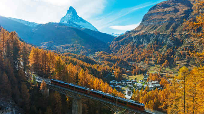 The Glacier Express traverses Findelbach bridge in the Swiss Alps
