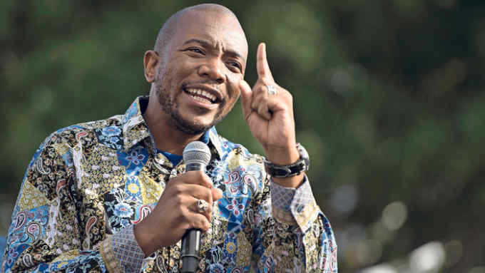 Mmusi Maimane, leader of the official opposition political party, the Democratic Alliance (DA), addresses people before a land expropriation hearing being held in a church in Cape Town, on August 4, 2018. - Teams from Parliament's Joint Constitutional Review Committee has been holding hearings throughout South Africa to hear South Africans' views on the amendment of Section 25 of the Constitution, which would allow the government to expropriate land without compensation. The South African president said on July 31 that his ruling party would seek to change the constitution to speed up redistribution of land to the country's poor black majority. White farmers control 73 percent of arable areas and it is widely understood to be that land which could be forcibly seized and transferred to the previously disadvantaged. (Photo by RODGER BOSCH / AFP) (Photo credit should read RODGER BOSCH/AFP/Getty Images)