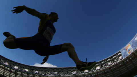 An athlete jumps during the men's triple jump qualifications at the 2013 IAAF World Championships at the Luzhniki stadium in Moscow on August 16, 2013. AFP PHOTO / ADRIAN DENNIS (Photo credit should read ADRIAN DENNIS/AFP/Getty Images)