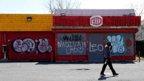 A man walks by a closed restaurant along Bergen Street, Thursday, April 26, 2018, in Newark, N.J. (AP Photo/Julio Cortez)