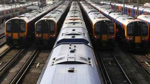 Southwest Trains passenger trains sit on tracks at Clapham Junction railway station, in London, U.K., on Wednesday, Feb. 24, 2016. The U.K. currency has tumbled this year amid concern that Britain will vote to leave the European Union, hampering trading and discouraging foreign investment. Photographer: Luke MacGregor/Bloomberg