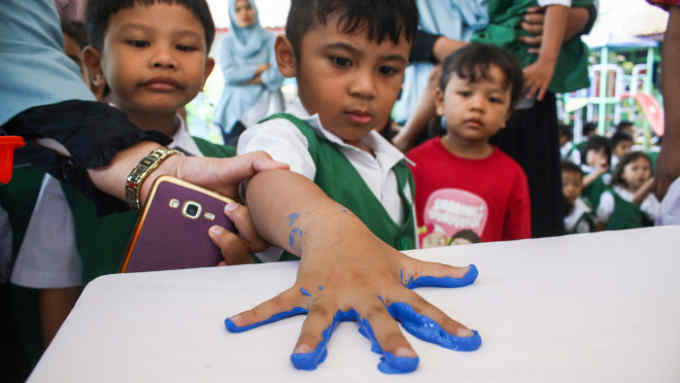 Making a mark: children handprinting in a Jakarta nursery school