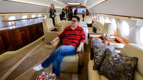 A Chinese man tries out the interior on an Airbus A319 private business jet during the Asian Business Aviation Conference and Exhibition (ABACE2014) at the Shanghai Hongqiao airport on April 14, 2014. Private plane ownership in China is still miniscule compared to countries like the US. State media reported only 150 such aircraft registered in 2011, despite an estimated one million millionaires as a result of the nation's economic boom. AFP PHOTO/Mark RALSTON (Photo credit should read MARK RALSTON/AFP/Getty Images)