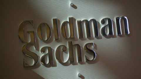 The Goldman Sachs & Co. logo is displayed at the company's booth on the floor of the New York Stock Exchange (NYSE) in New York, U.S., on Friday, July 19, 2013. U.S. stocks fell after benchmark equities gauges rose to records yesterday, as worse-than-estimated profit from Google Inc. and Microsoft Corp. (MSFT) overshadowed China’s plan to remove the floor on lending rates. Photographer: Scott Eells/Bloomberg
