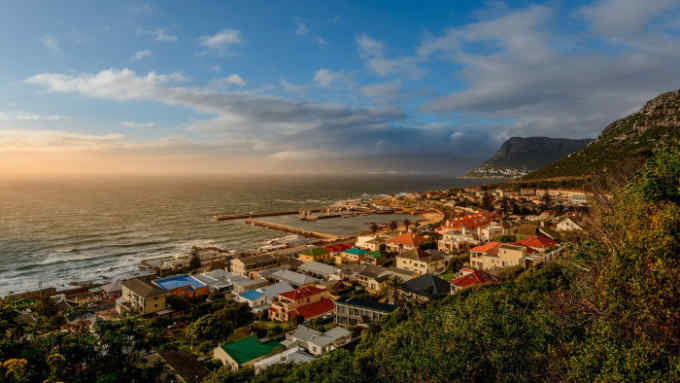 View over Kalkbaai or Kalk Bay showing harbor, Cape Town, Western Cape, South Africa. (Photo by: Education Images/UIG via Getty Images)