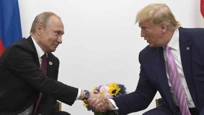 President Donald Trump, right, shakes hands with Russian President Vladimir Putin during a bilateral meeting on the sidelines of the G-20 summit in Osaka, Japan, Friday, June 28, 2019. (AP Photo/Susan Walsh)