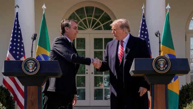 U.S. President Donald Trump shakes hands with Brazil's President Jair Bolsonaro during a joint news conference in the Rose Garden of the White House in Washington, U.S., March 19, 2019. REUTERS/Kevin Lamarque - RC1CBEF2DE60