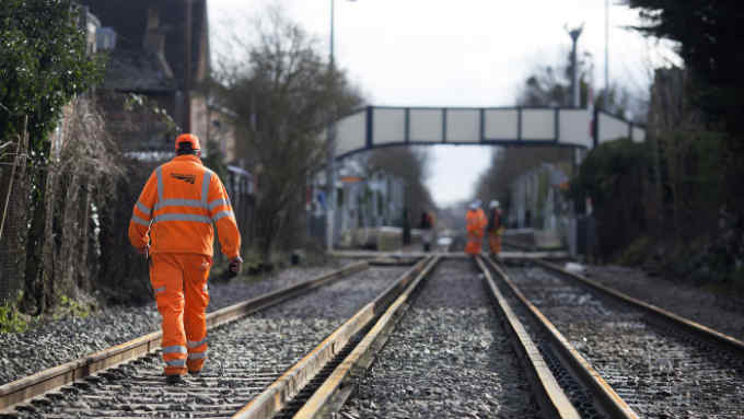 Network Rail Ltd. workers assess damage to rail tracks following flooding at Datchet station in Datchet, U.K., on Thursday, Feb. 13, 2014. The flood risk for London commuter towns, many of which are already inundated, will rise in the coming days as more rain and dangerous winds sweep Britain. Photographer: Simon Dawson/Bloomberg