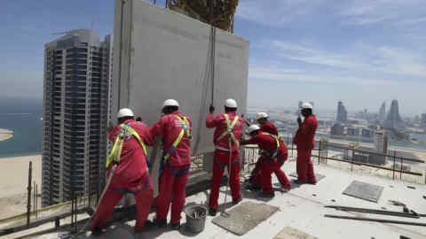 One of the last pre-cast concreate panels, is lifted onto the top of the The Breaker in Manama, May 7, 2014. The 35-storey, 150-metre-tall, residential development is being constructed from pre-cast concrete material, accoring to General Manager of the Bahrain Pre-Cast Concrete Company Michael Pedersen. REUTERS/Hamad I Mohammed (BAHRAIN - Tags: BUSINESS CONSTRUCTION REAL ESTATE) - GM1EA571LM201