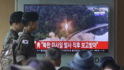 Army soldiers walk by a TV news program showing a file image of a missile being test-launched by North Korea at the Seoul Railway Station in Seoul, South Korea, Tuesday, July 4, 2017. North Korea on Tuesday launched yet another ballistic missile in the direction of Japan, South Korean officials said, part of a string of recent test-firings as the North works to build a nuclear-tipped missile that could reach the United States. The signs read &quot;The presidential Blue House was briefed immediately after the North Korean missile was fired.&quot; (AP Photo/Ahn Young-joon)
