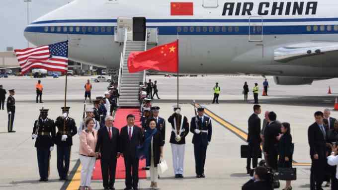US Secretary of State Rex Tillerson (2nd L) and his wife Renda St. Clair (L) greet the President of the People's Republic of China Xi Jinping (2nd R) and his wife Peng Liyuan (R) as they arrive to Palm Beach International Airport on Thursday, April 6, 2017 in West Palm Beach, Fla. / AFP PHOTO / Michele Eve Sandberg        (Photo credit should read MICHELE EVE SANDBERG/AFP/Getty Images)