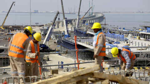 A photo taken on February 11, 2017 in Kuwait City shows labourers working at a construction site of the Sheikh Jaber Al-Ahmad Al-Sabah causeway, one of the largest infrastructure projects to be constructed. Kuwait is building a large causeway to connect the capital city, Kuwait City, with areas located north of Kuwait Bay where mega projects are planned in the future. / AFP / Yasser Al-Zayyat (Photo credit should read YASSER AL-ZAYYAT/AFP/Getty Images)