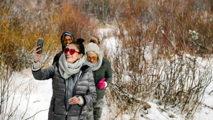 Participants take a short hike in the snow on Saturday afternoon.  Rose-colored glasses enhance the experience of viewing the landscape under the influence of THC.
