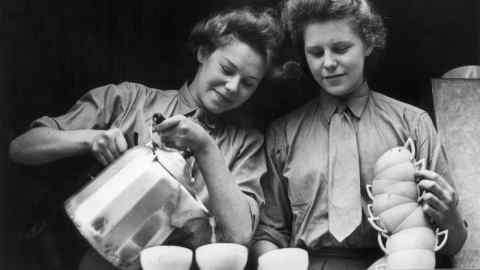 Auxiliary Territorial Service volunteers pour cups of tea in the canteen of a second world war Vehicle Reserve depot