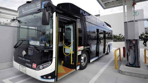 A Toyota Motor Corp. Sora fuel-cell bus sits parked next to a hydrogen dispenser during the opening ceremony of the Toyosu Hydrogen Station, jointly built by Tokyo Gas Co. and Japan H2 Mobility LLC (JHyM), in Tokyo, Japan, on Thursday, Jan. 16, 2020. The latest filling station that will be used to service Toyota's fuel cell buses during the 2020 Olympics and Paralympic Games opens Thursday near Tokyo's fish market. Photographer: Kiyoshi Ota/Bloomberg