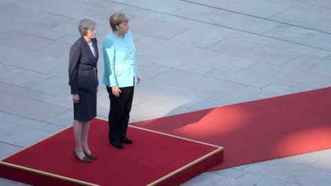 German Chancellor Angela Merkel and Britain's Prime Minister Theresa May (L) review the honour guard during a welcoming ceremony at the Chancellery in Berlin, Germany July 20, 2016. REUTERS/Stefanie Loos