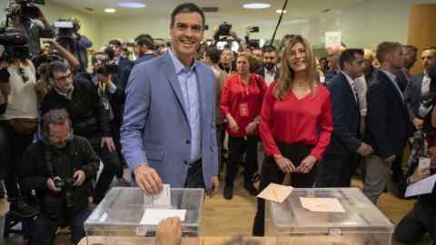 POZUELO DE ALARCON, SPAIN - APRIL 28: Spain's Prime Minister and Spanish Socialist Workers' Party (PSOE) leader Pedro Sanchez (L) poses for photographers as he cast his vote while his wife Maria Begona Gomez (R) stands behind at a polling station during the Spanish General Elections on April 28, 2019 in Pozuelo de Alarcon, Madrid province, Spain. Spaniards went to the polls today to vote for 350 members of the parliament and 208 senators. This is the 13th General Election since the transition to democracy resulting in the Constitution of 1978. There are five main parties: the two traditional parties are right-wing Partido Popular (People's Party) and centre-left Partido Socialista Obrero Espanol or PSOE (Spanish Socialist Workerss Party), along with right-wing Ciudadanos (Citizens) and left wing Podemos (We Can) and the fifth is the far-right party VOX. (Photo by Pablo Blazquez Dominguez/Getty Images)