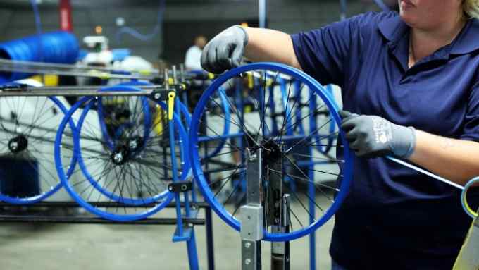 An employee prepares wheel frames for the Boys MT20 model bicycle at The Kent International Inc. Bicycle Corporation of America brand Assembly facility in Manning, South Carolina, U.S., on Sunday, June 25, 2017. Almost all of the roughly 18 million bicycles sold each year in the U.S. come from China and Taiwan. This year, about 130 workers at the Bicycle Corporation of America's new factory will assemble 350,000 bikes in the U.S. Photographer: Travis Dove/Bloomberg