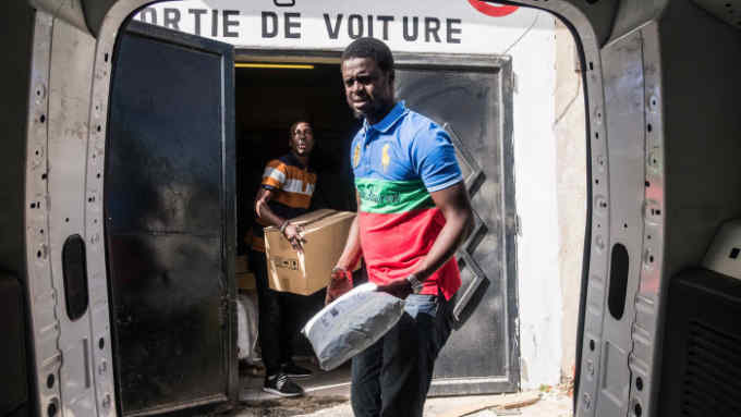 Dakar Senegal (March 14, 2018) - Lamine Niang and Antoine da Silva load the truck of packages for delivery for Oui Carry.